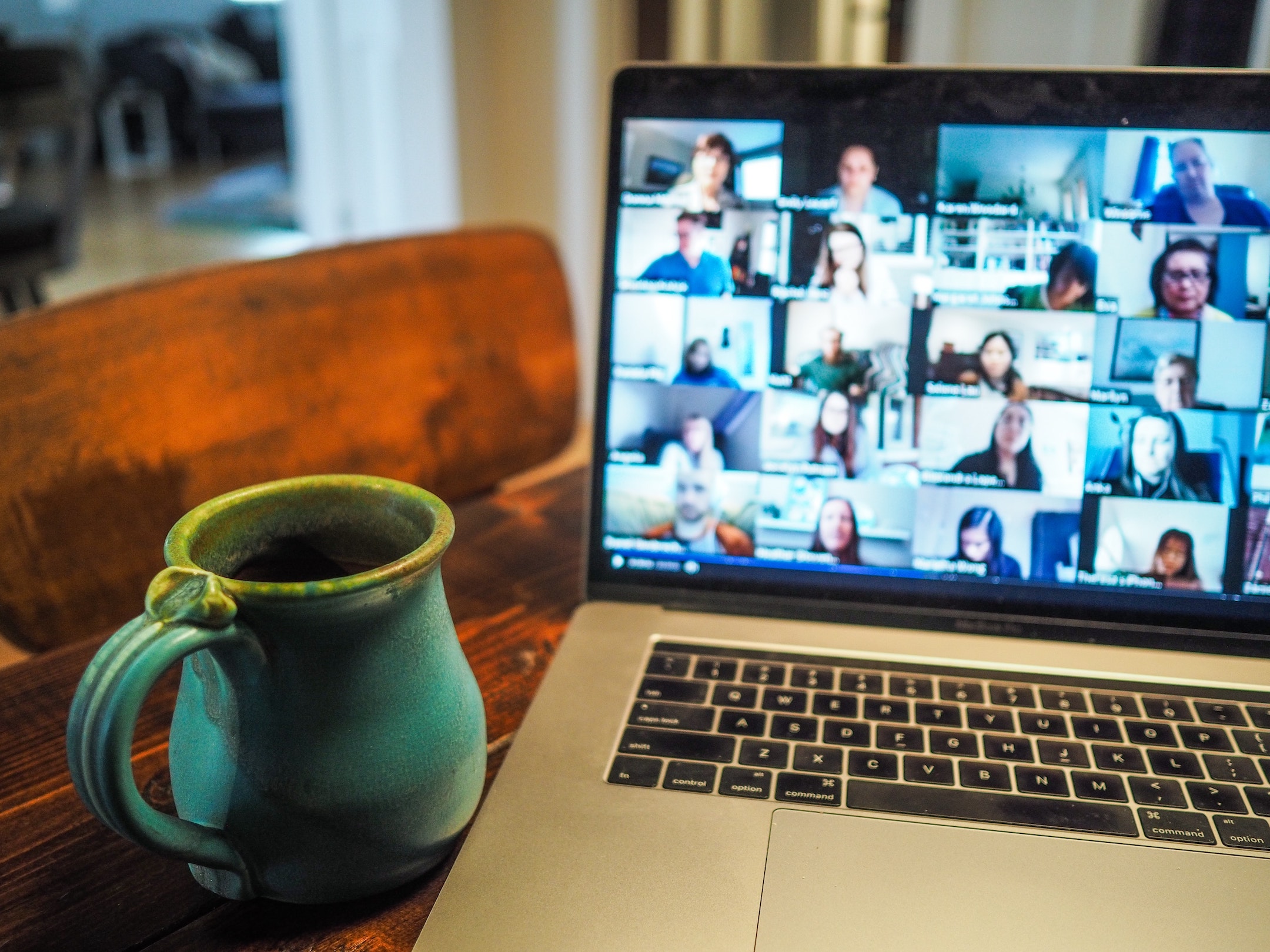 online meeting on laptop and coffee mug